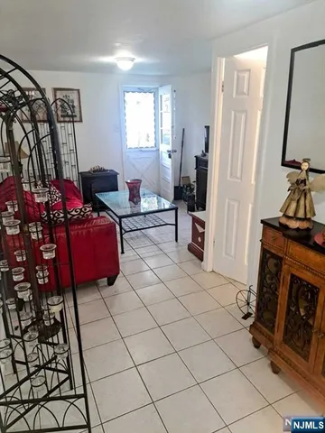a living room with furniture a flat screen tv and a window