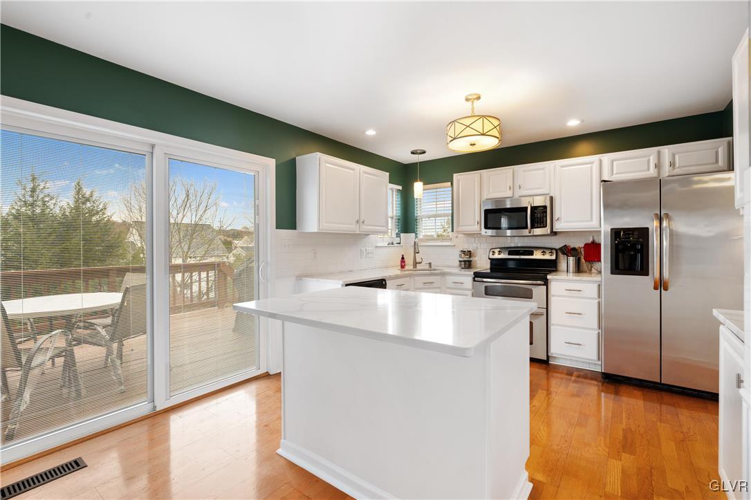2229 Juniper Drive Coplay, PA 18037 - Photo 12 of 52 a kitchen with kitchen island granite countertop a sink cabinets and stainless steel appliances