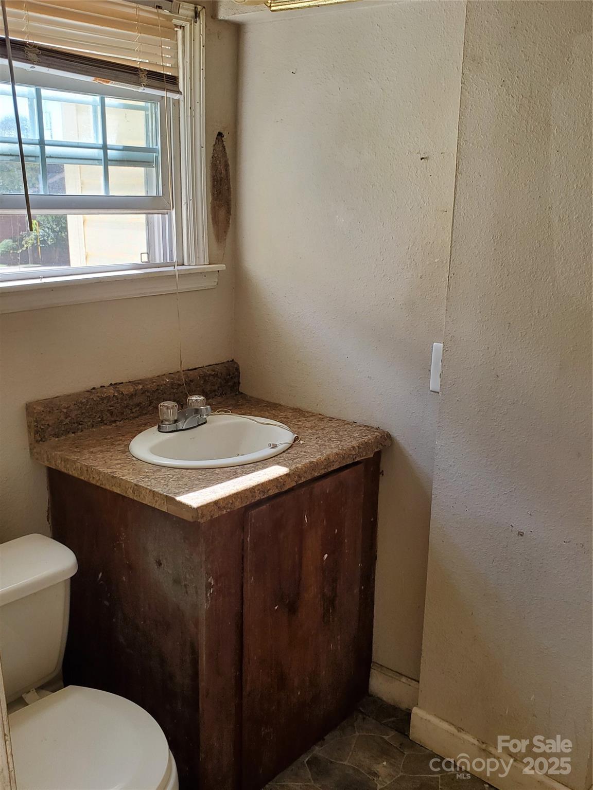 414 South Rowan Avenue Spencer, NC 28159 - Photo 11 of 15 a bathroom with a sink and a toilet