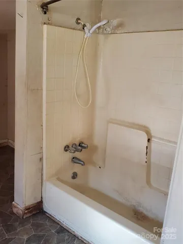 a bathroom with a shower and a bath tub