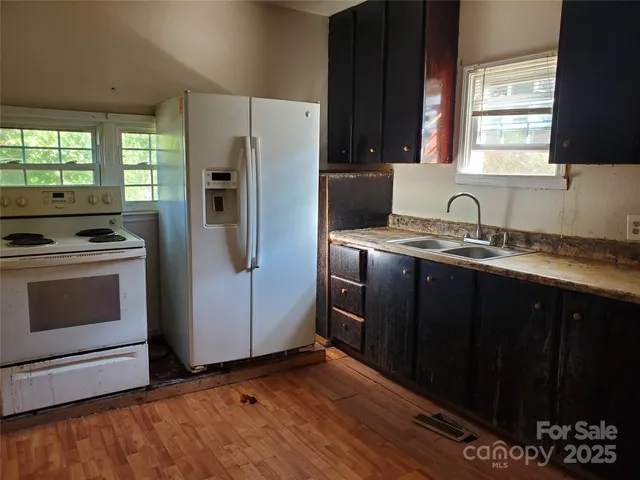 a kitchen with a refrigerator stove and sink