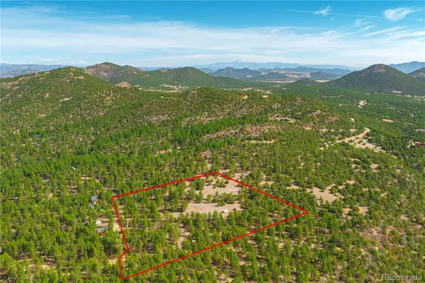 a view of a mountain range with lush green hillside