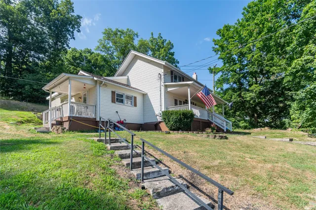 a view of a backyard with swimming pool