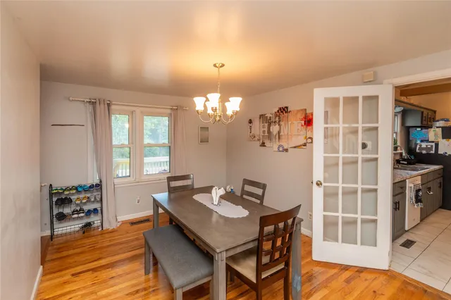 a view of a dining room with furniture and chandelier