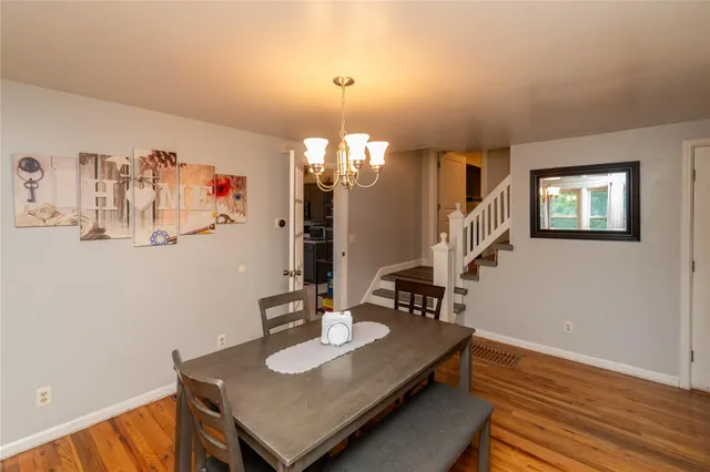 a view of a dining room with furniture and chandelier