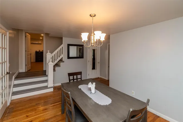 a view of a dining room with furniture and a chandelier
