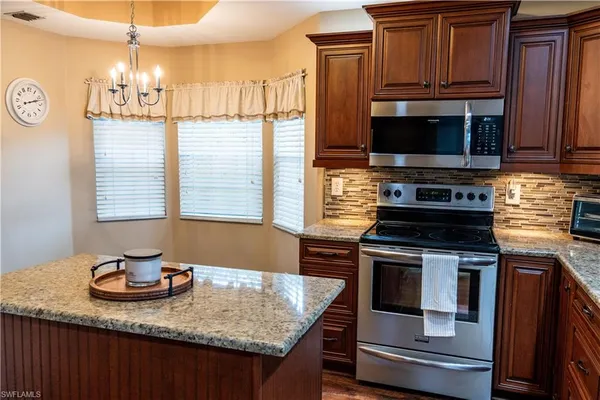 a kitchen with a refrigerator and potted plant