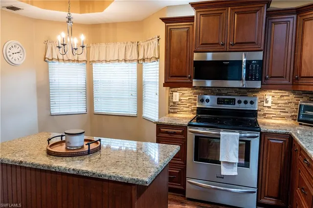 a kitchen with a refrigerator and potted plant