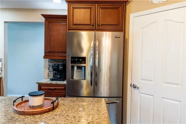 a bathroom with a granite countertop toilet sink and mirror