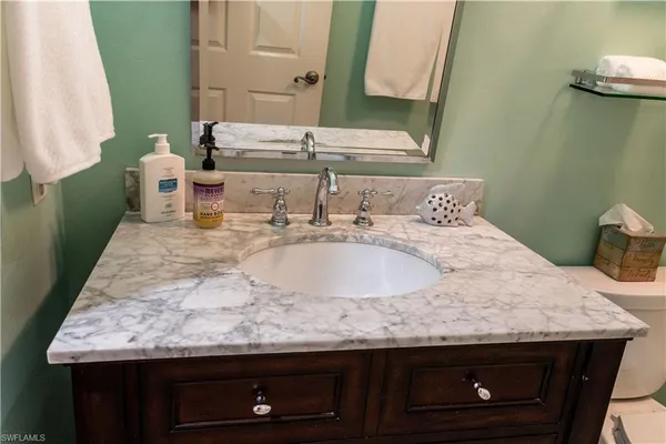 a large bed sitting in a bedroom next to a window