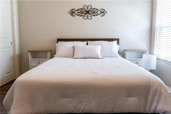 a bedroom with a bed and window