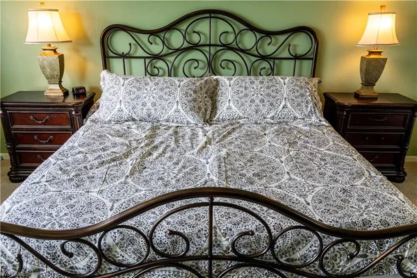 a bedroom with a bed and a table chair