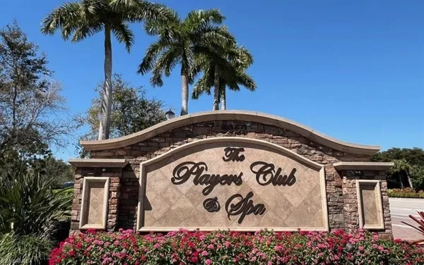 a view of a white house with a yard and potted plants