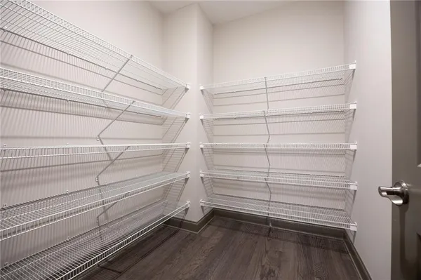 a view of walk in closet with empty racks
