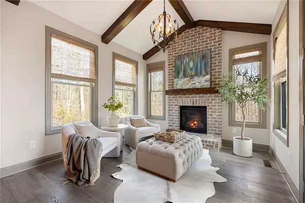 a living room with furniture a fireplace and a flat screen tv