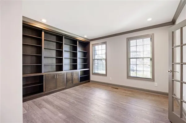 a kitchen with kitchen island a sink stainless steel appliances and white cabinets