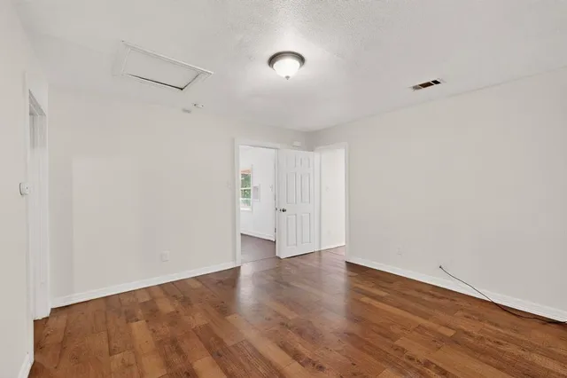 a view of a kitchen with a sink wooden floor and a window
