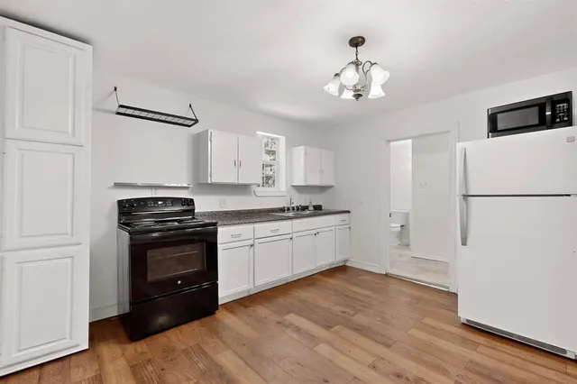 a view of a kitchen with a sink and cabinet