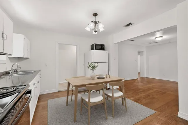 a bedroom with a bed lamp and a potted plant