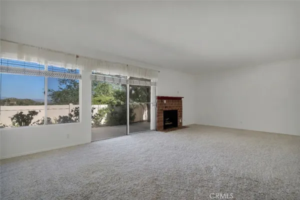 an empty room with furniture and a fireplace