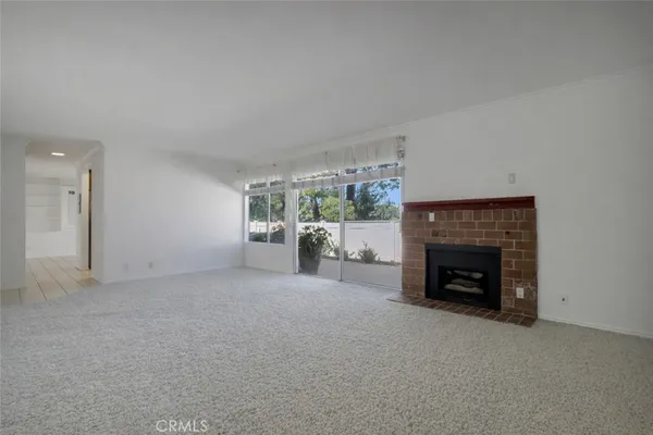 a view of empty room with furniture and fireplace