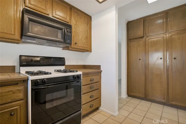 a kitchen with granite countertop cabinets stainless steel appliances and a wooden floor