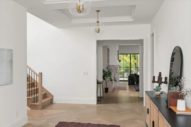 a living room with furniture and a potted plant