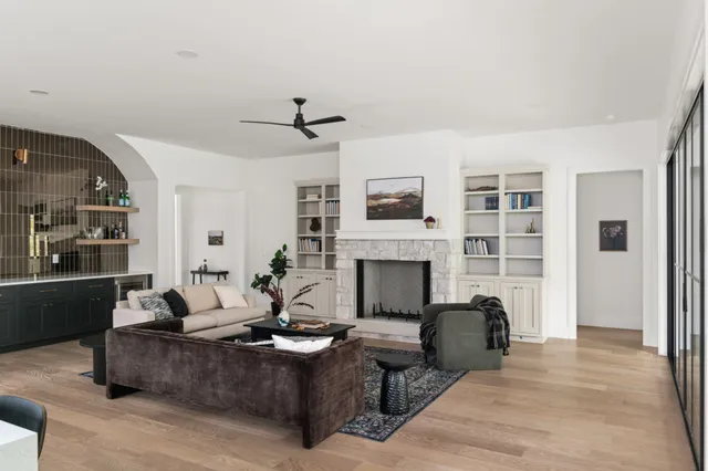 a living room with furniture and wooden floor