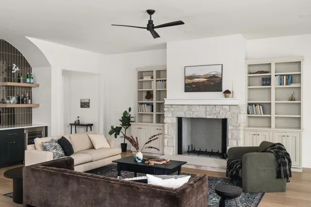 a living room with furniture a window and a potted plant