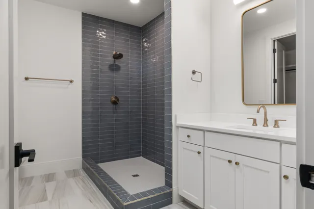 a bathroom with a sink a toilet and a mirror