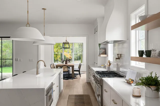 a kitchen with sink stove and refrigerator