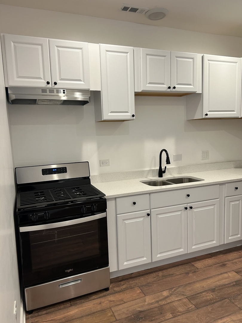 6016 South St Lawrence Avenue, Unit 1 Chicago, IL 60637 - Photo 15 of 16 a kitchen with white cabinets and appliances