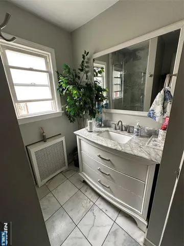 a bathroom with a granite countertop toilet and a sink