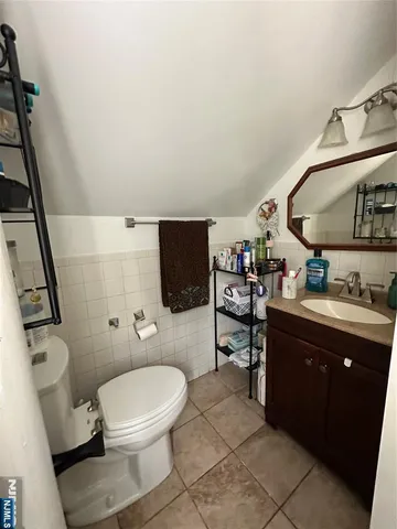 a bed sitting in a bedroom next to a lamp