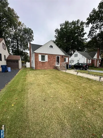 a large house with a large tree in front of it