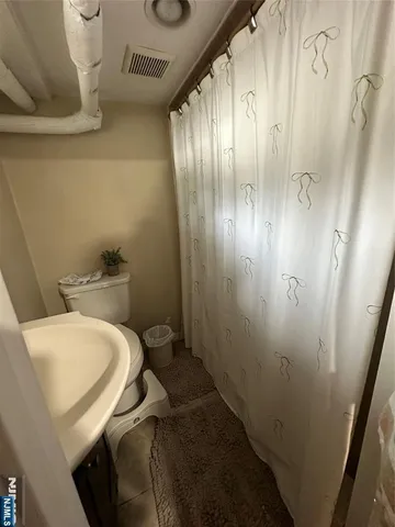 a view of house with a big yard and potted plants