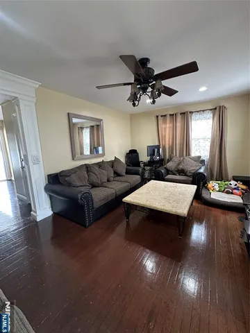 a living room with furniture and a chandelier