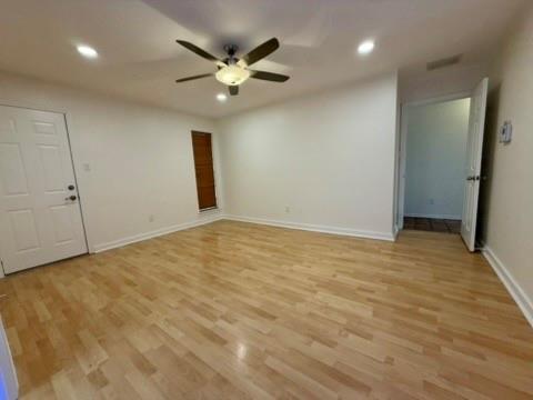 5045 Thunder Road Dallas, TX 75244 - Photo 6 of 28 an empty room with a chandelier fan and kitchen view