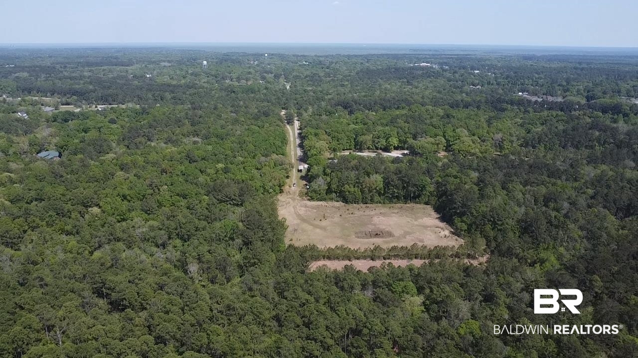 0 I-65 Service Road Satsuma, AL 36572 - Photo 2 of 27 Drone / aerial view featuring a wooded view