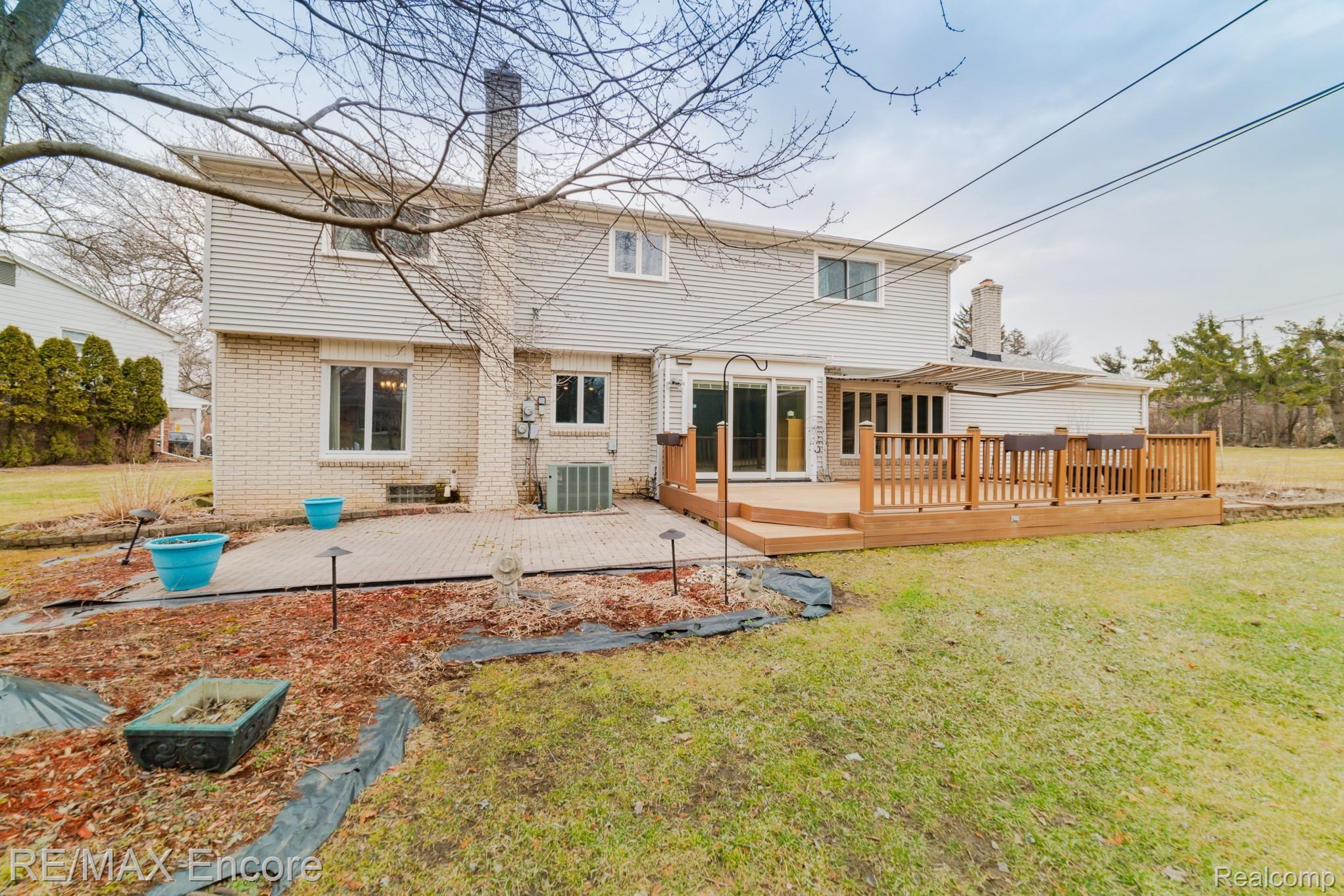 948 Spartan Court Rochester, MI 48309 - Photo 40 of 41 Brick paver patio off of deck... a perfect entertaining space!