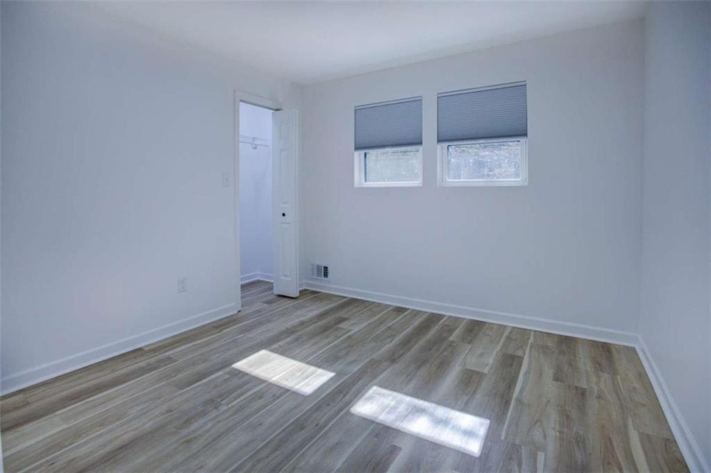 7225 Pineneedle Drive Southwest Covington, GA 30014 - Photo 26 of 37 an empty room with wooden floor and windows