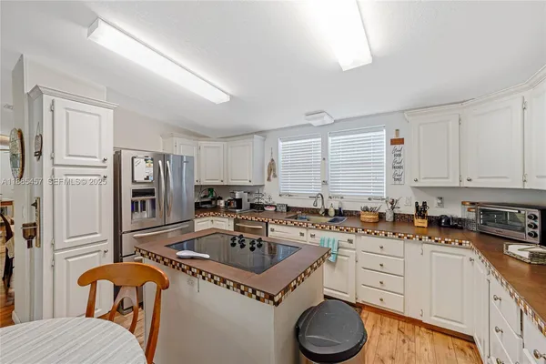 a living room with furniture kitchen view and a window