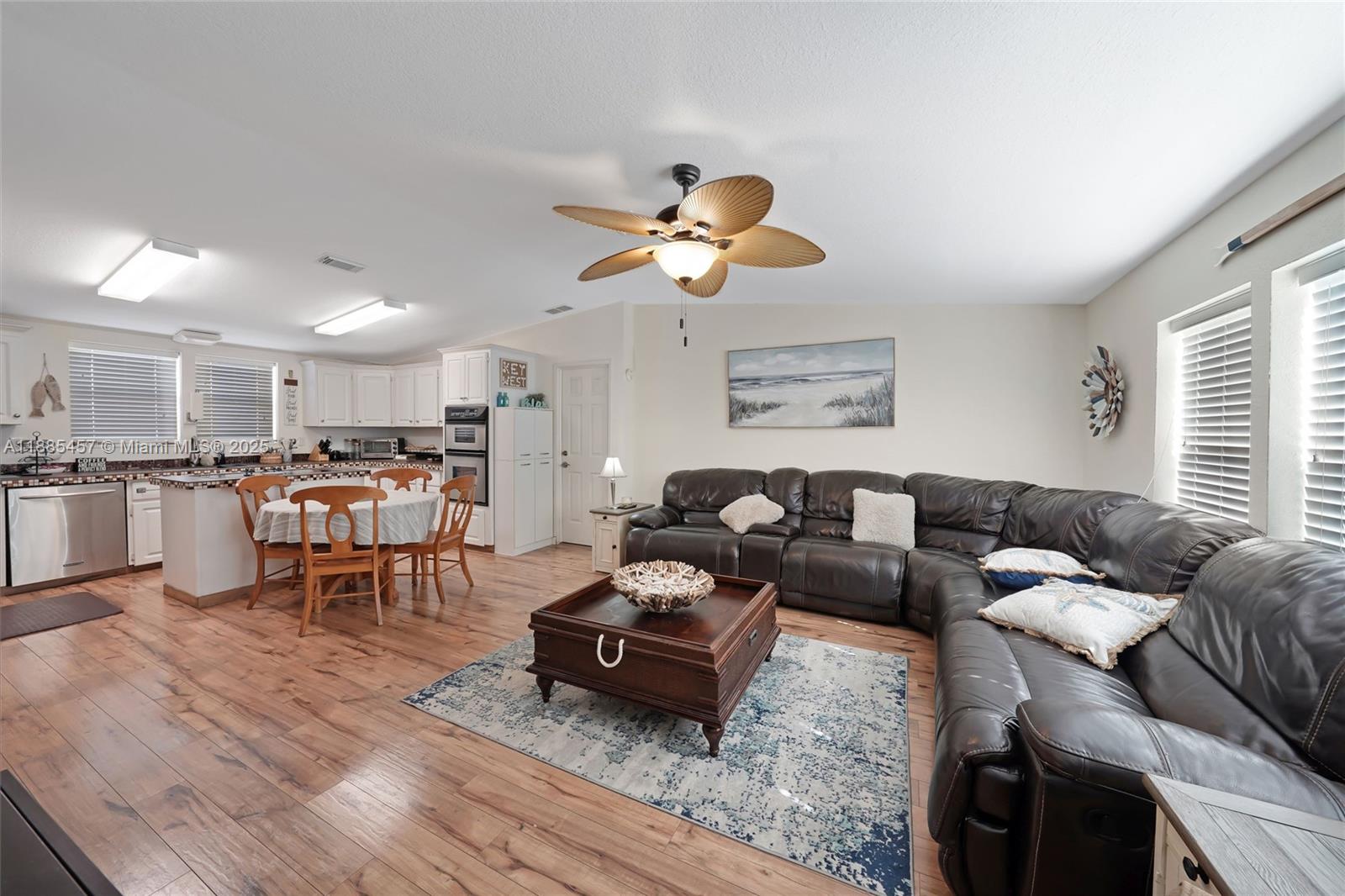 945 Plantation Road, Unit 945 Key Largo, FL 33037 - Photo 16 of 66 a living room with furniture kitchen view and a chandelier