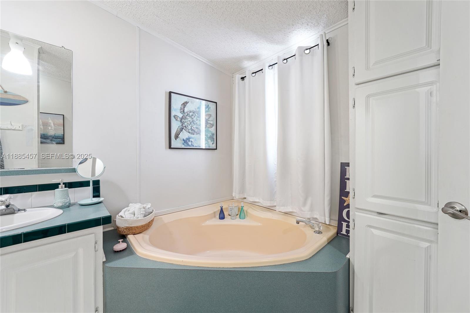 945 Plantation Road, Unit 945 Key Largo, FL 33037 - Photo 21 of 66 a white bath tub sitting next to a white sink