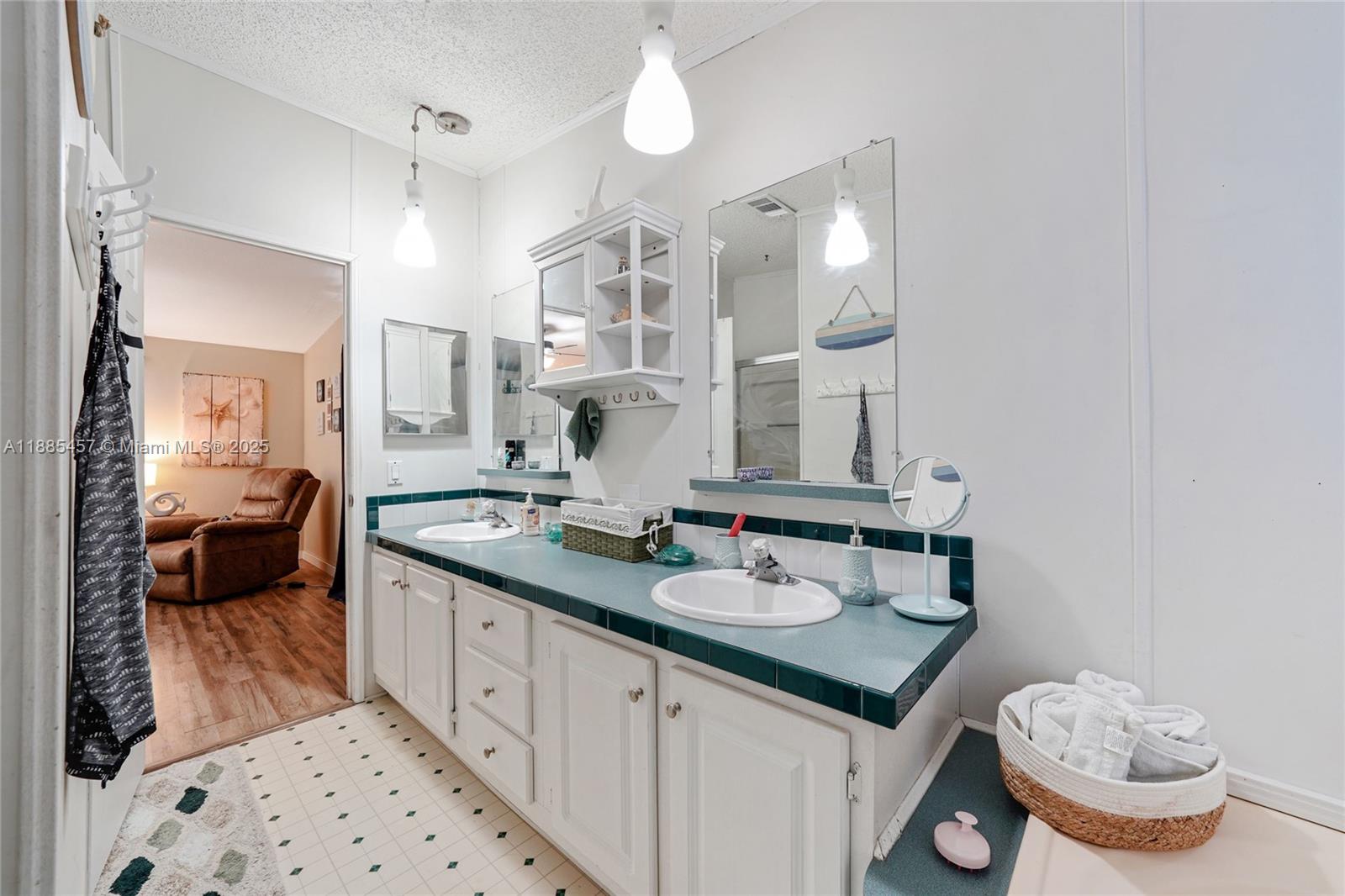 945 Plantation Road, Unit 945 Key Largo, FL 33037 - Photo 22 of 66 a spacious bathroom with a sink double vanity and a mirror