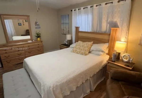 a bedroom with a bed and a dresser