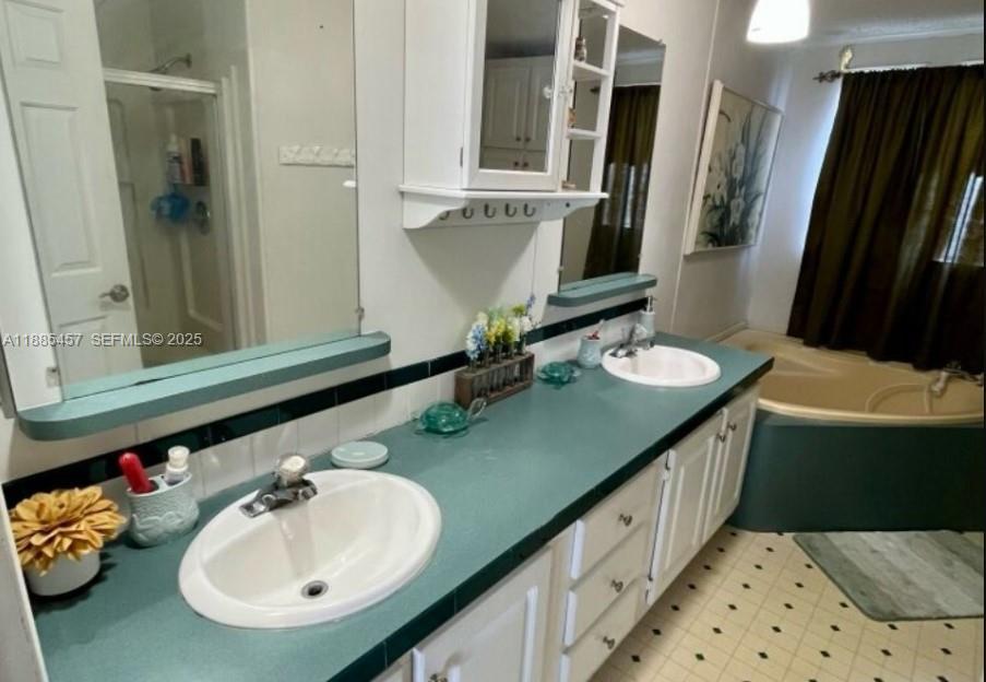 945 Plantation Road, Unit 945 Key Largo, FL 33037 - Photo 27 of 66 a bathroom with a double vanity sink and a mirror