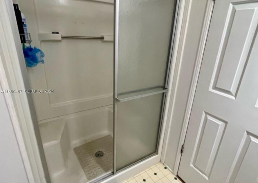 945 Plantation Road, Unit 945 Key Largo, FL 33037 - Photo 28 of 66 a bathroom with a glass door shower and a sink