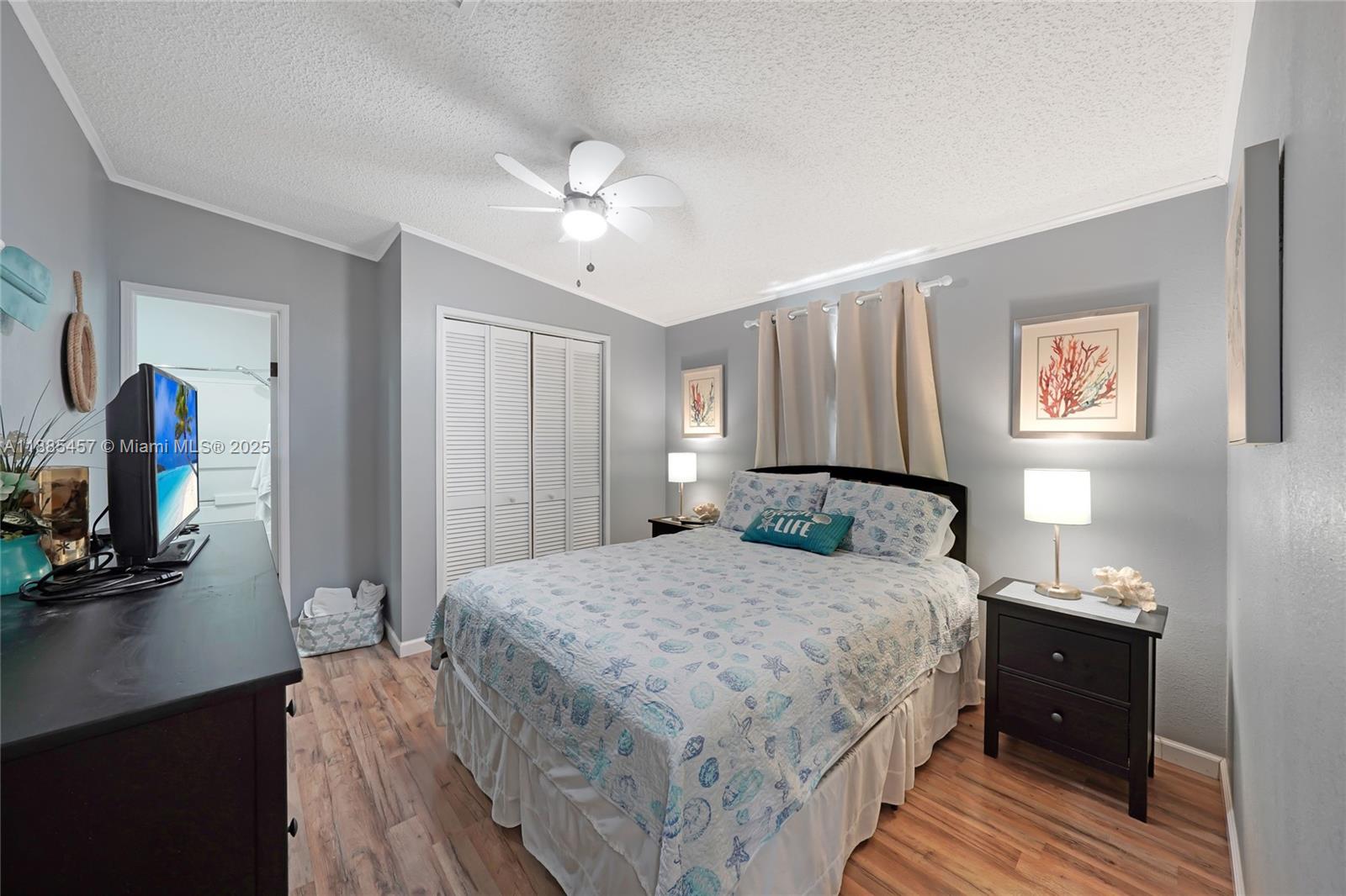 945 Plantation Road, Unit 945 Key Largo, FL 33037 - Photo 29 of 66 a bedroom with a bed and a flat tv screen on dresser