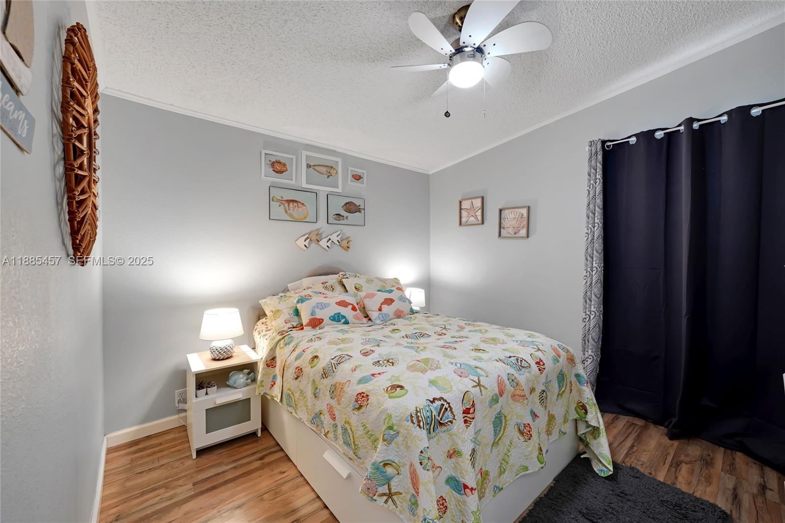 945 Plantation Road, Unit 945 Key Largo, FL 33037 - Photo 32 of 66 a bedroom with a bed and a chandelier